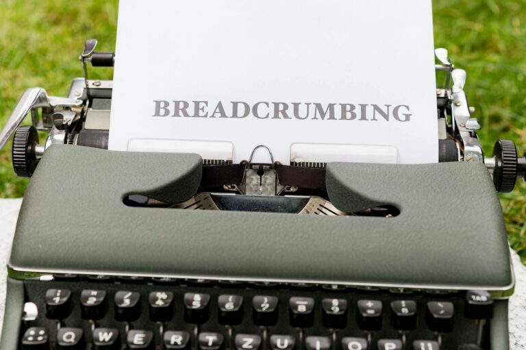 A typewriter with a paper that says breadcrumbing